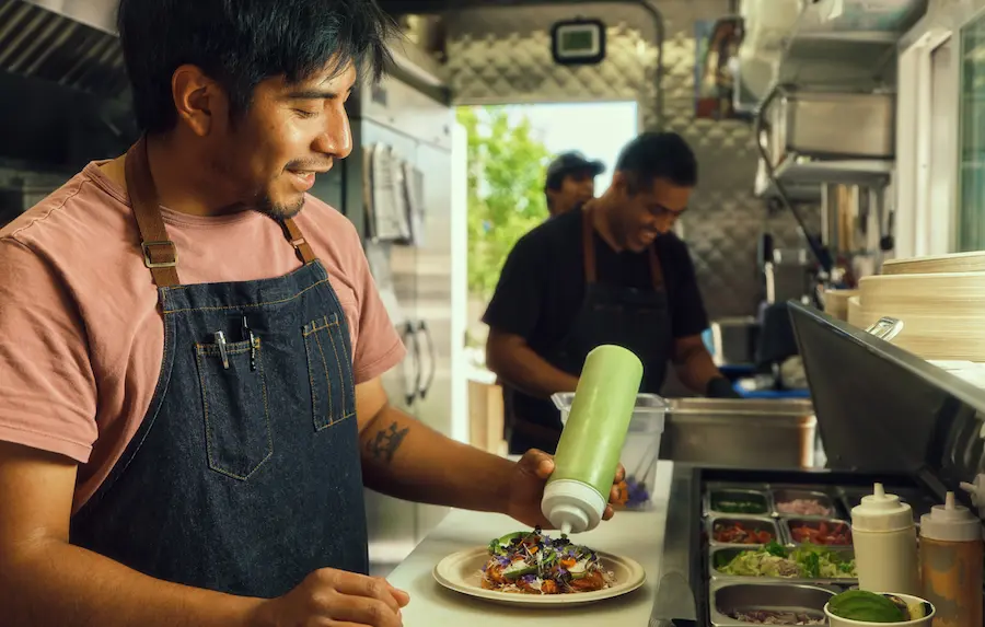 Dos Mundos food truck, fresh ingredients neatly arranged nearby.