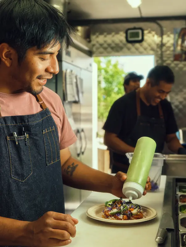 Dos Mundos food truck, fresh ingredients neatly arranged nearby.