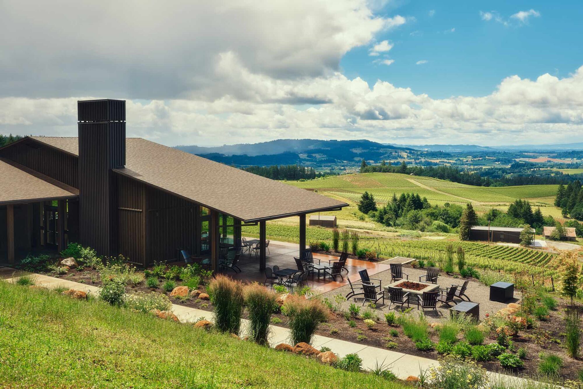 View of the L'Angolo Estate tasting room patio and surrounding countryside